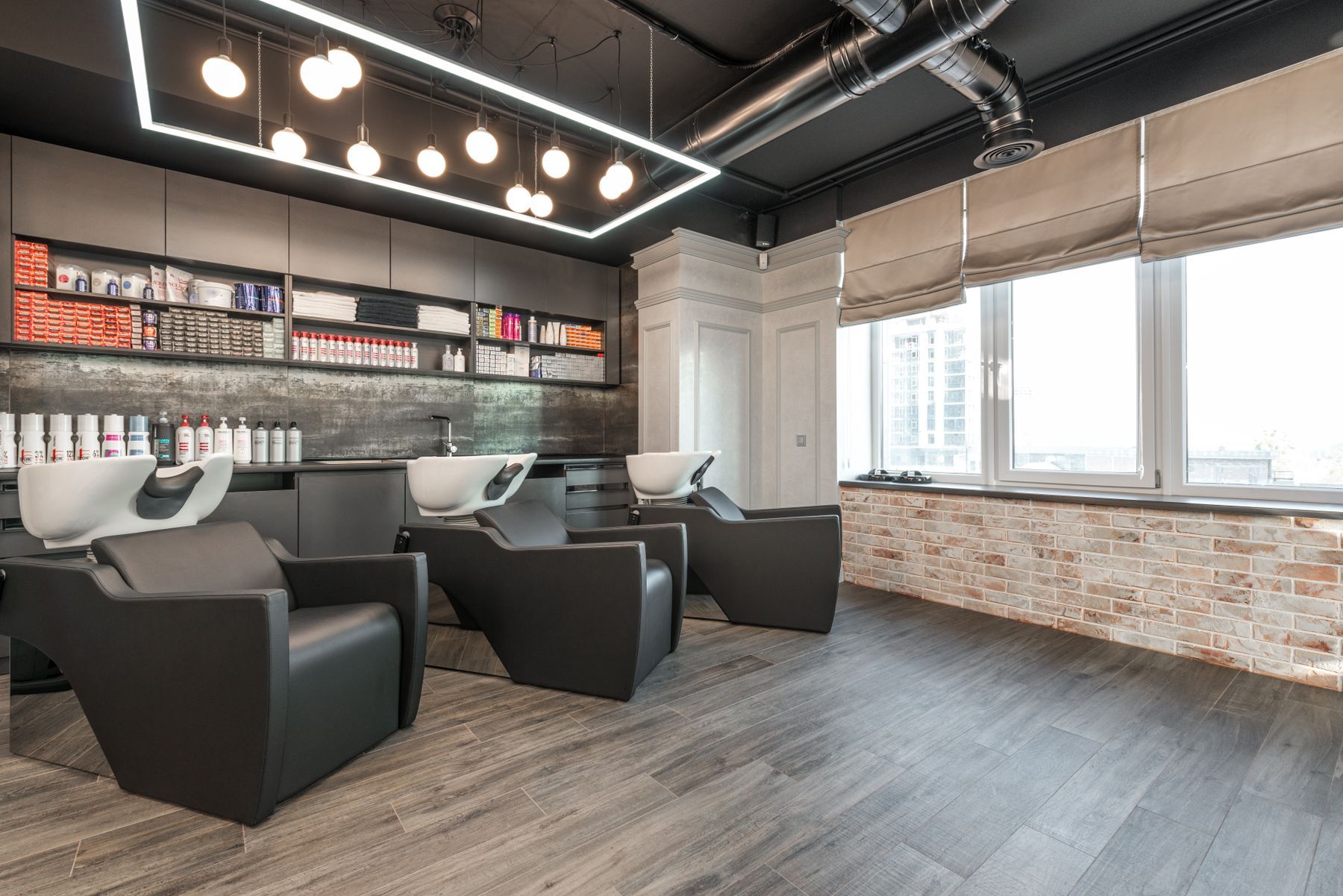 Shampoo bowls and backwash chairs in a clean, modern beauty salon