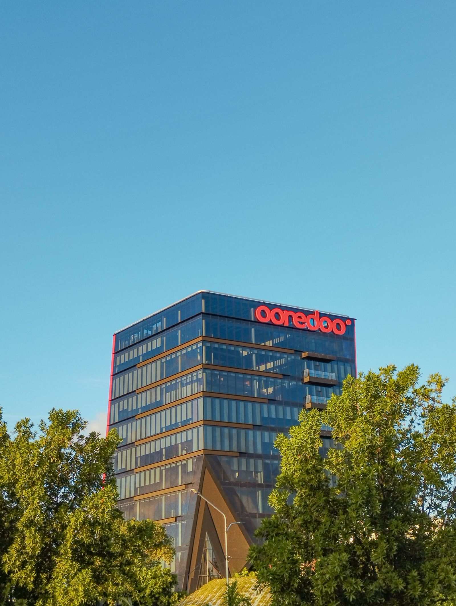 Modern glass office building under a clear sky