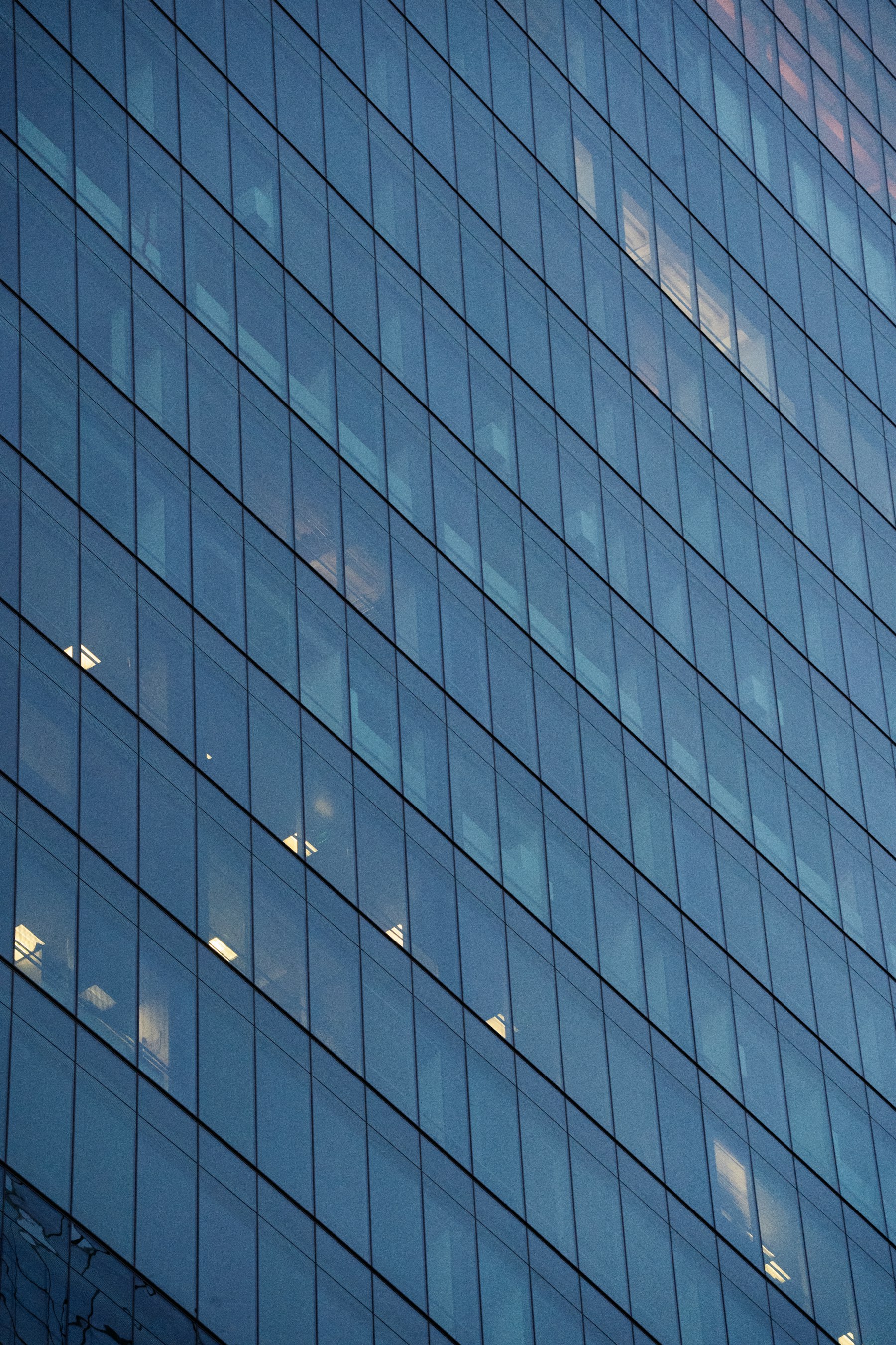 Modern glass office building facade at dusk