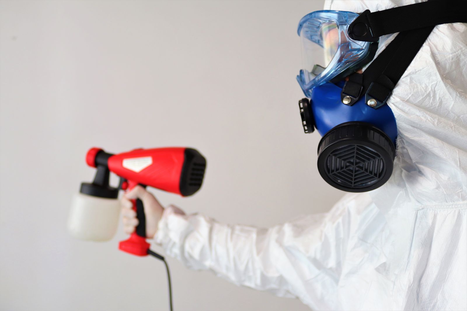 Technician applying disinfectant with a handheld sprayer